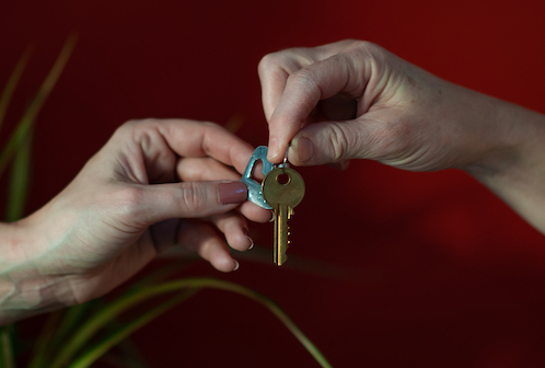 Person being handed a set of keys