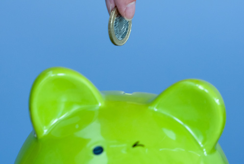 Money being put into a piggy bank